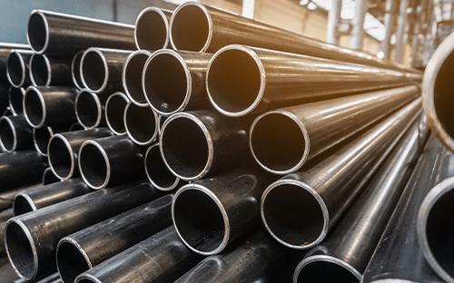 Stack of metal pipes of various diameters showing industrial piping used for transporting fluids