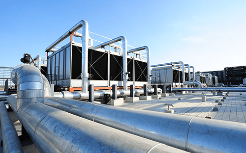 Industrial cooling units and piping installed on the roof of a data center