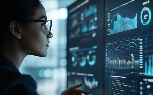 Analyste consultant un tableau de bord num&eacute;rique affichant des graphiques de suivi des &eacute;missions et indicateurs de performance